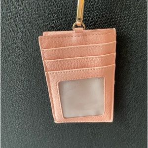 Pink credit card/wallet lanyard. Credit card slots outside, zip close interior.